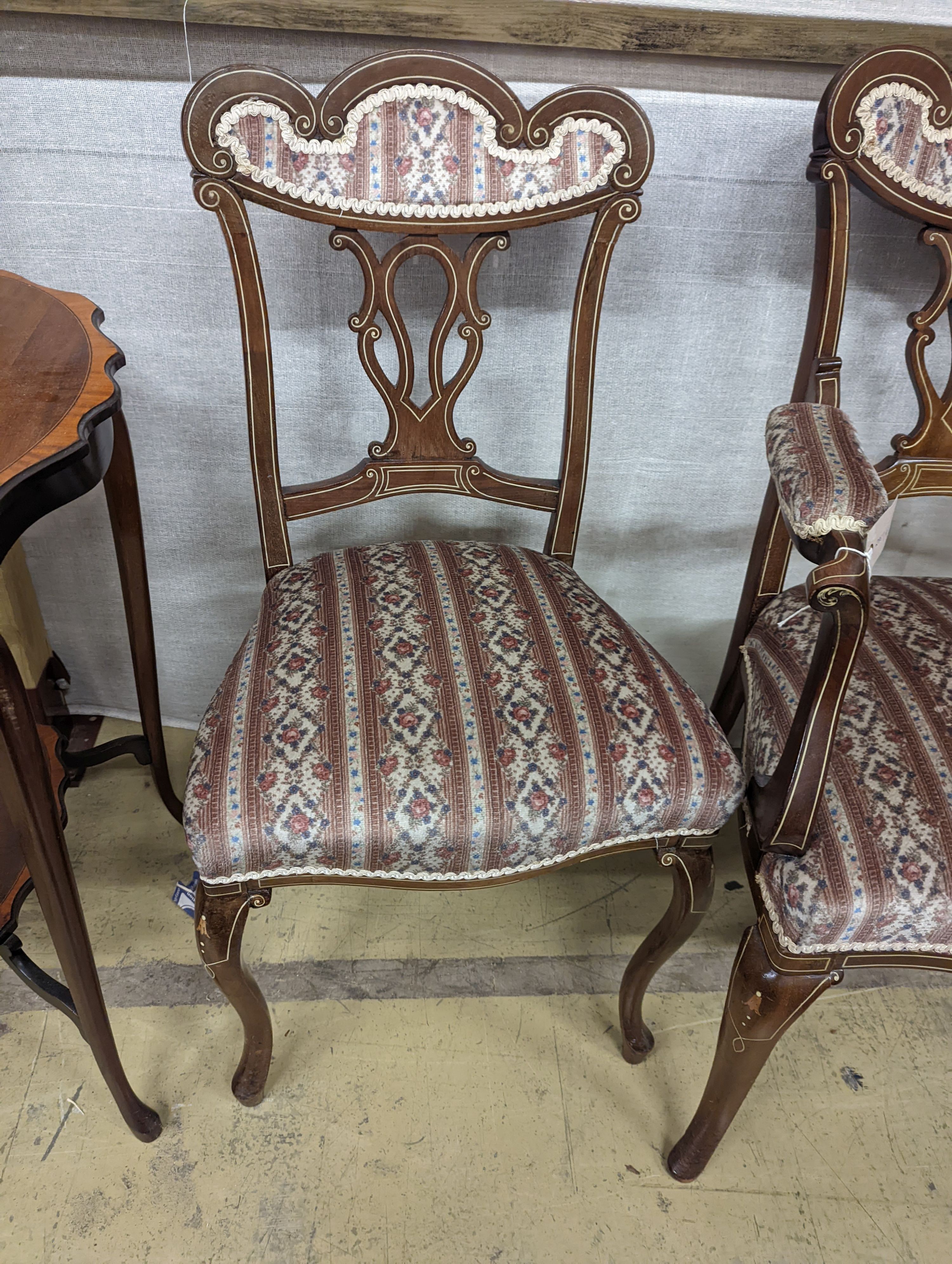 Three late Victorian bone inlaid mahogany chairs, two with arms, together with an Edwardian oval satinwood banded occasional table.